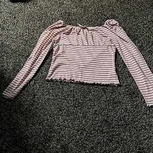 This is a long sleeved Children’s place top. It includes pink, white, & green